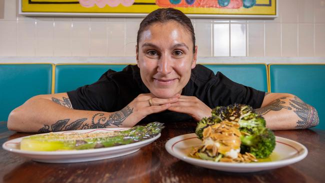 Senior chef Caitlin Lemish with two of the seasonal plant-based dishes at Africola restaurant in Adelaide’s East End. Picture: Ben Clark