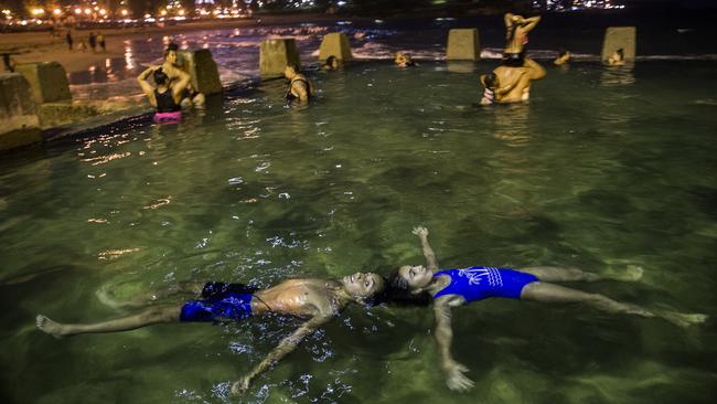 Siblings Christian Nehme and Chloe Nehme cooling off during a hot Sydney evening. Picture: Dylan Robinson