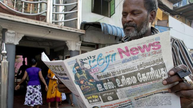 A man reads a newspaper with a lead story on Islamic State taking responsibility. Picture: Gemunu Amarasinghe/AP