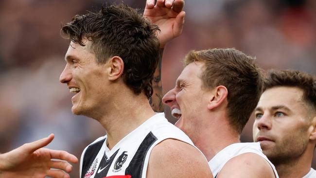 MELBOURNE, AUSTRALIA - APRIL 25: Brody Mihocek of the Magpies celebrates a goal with teammates Will Hoskin-Elliott and Jamie Elliott during the 2024 AFL Round 07 match between the Essendon Bombers and the Collingwood Magpies at the Melbourne Cricket Ground on April 25, 2024 in Melbourne, Australia. (Photo by Dylan Burns/AFL Photos via Getty Images)