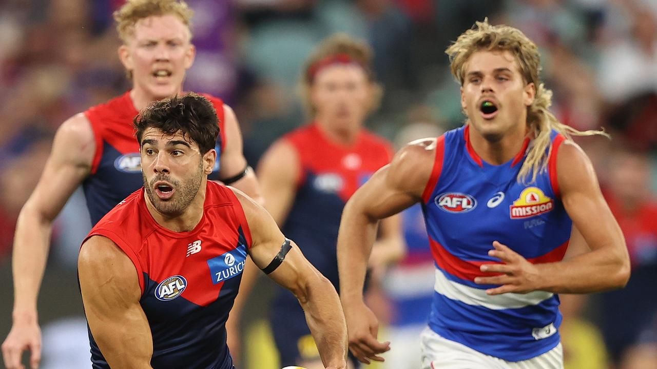 MELBOURNE, AUSTRALIA - MARCH 16: Christian Petracca of the Demons runs with the ball during the round one AFL match between the Melbourne Demons and the Western Bulldogs at the Melbourne Cricket Ground on March 16, 2022 in Melbourne, Australia. (Photo by Robert Cianflone/Getty Images)