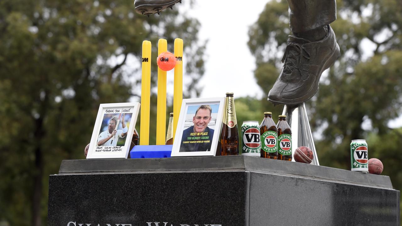 MELBOURNE, AUSTRALIA - NewsWire Photos MARCH 05, 2022: Flowers and other tributes at the statue of Shane Warne at the Melbourne Cricket Ground after the cricket legend died suddenly overnight. Picture: NCA NewsWire / Andrew Henshaw