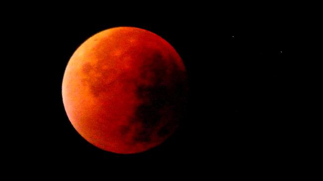 Sometimes called a blood moon, it is a rare astronomical event when a swollen super moon and lunar eclipse combine. Picture: Rémy Mantione