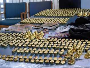 Fake gold Buddha statues and ingots seized by police are alleged to have been used to scam people. Picture: Chloe Lyons