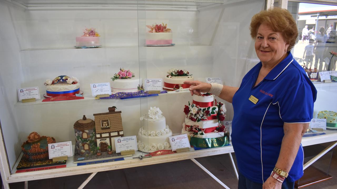 Cake judging steward Bev Hibberd displays decorated cakes at the Fraser Coast Ag Show.