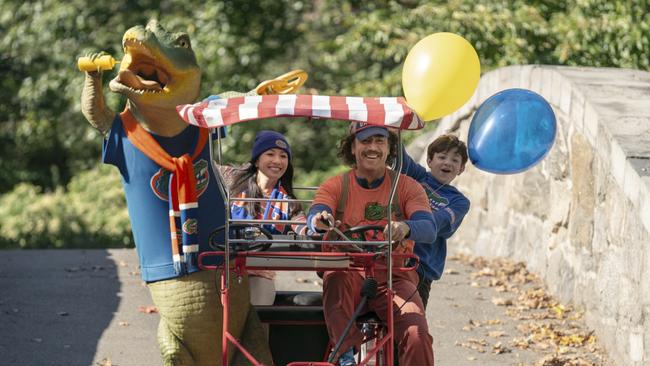 Lyle (Lyle the Crocodile), Mrs. Primm (Constance Wu), Hector P. Valenti (Javier Bardem) and Josh Primm (Winslow Fegley) ride a pedal bike in New York in Columbia. Picture: Supplied/Sarah Shatz