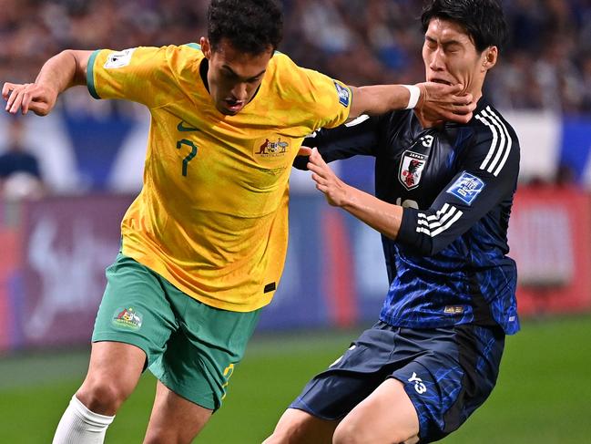 SAITAMA, JAPAN - OCTOBER 15: Nishan Velupillay of Australia controls the ball against Daichi Kamada of Japan during the FIFA World Cup Asian Third Qualifier Group C match between Japan and Australia at Saitama Stadium on October 15, 2024 in Saitama, Japan.  (Photo by Kenta Harada/Getty Images)