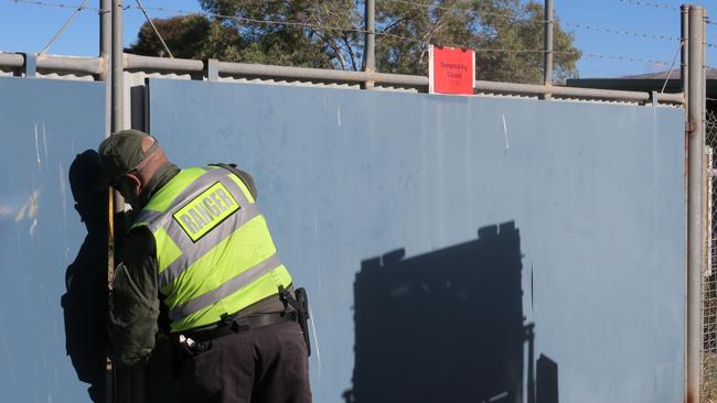 An Alice Springs Town Council ranger shuts the gate at the Alice Springs Animal Shelter. Picture: Gera Kazakov.