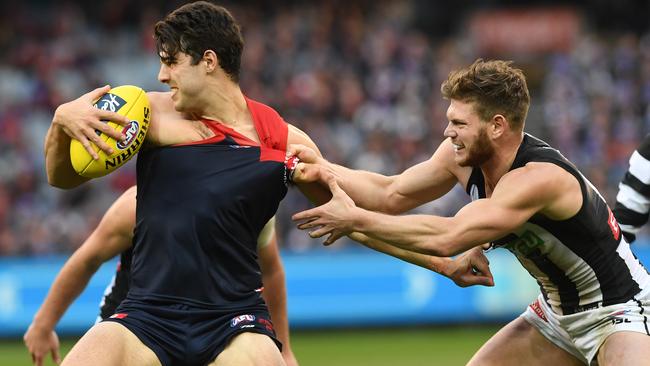 Christian Petracca tries to shrug off Taylor Adams.