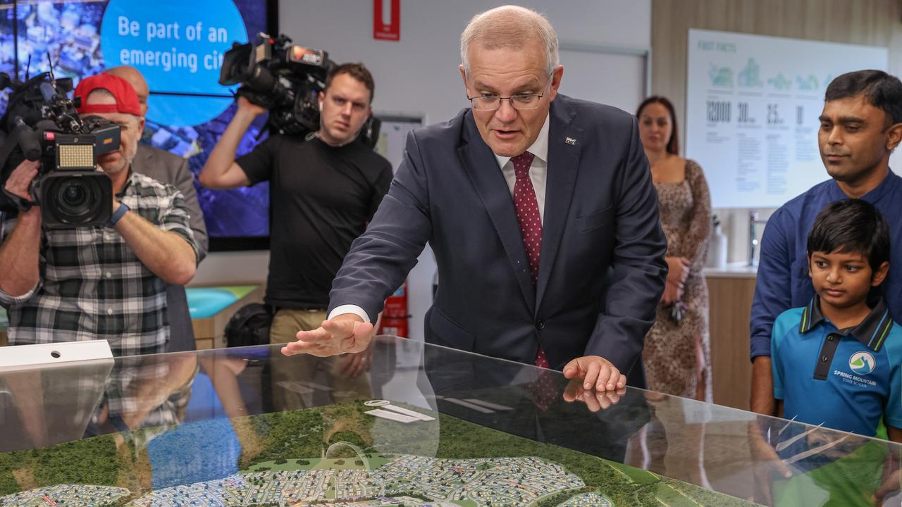 The PM examined a model of the housing estate development while visiting the Springfield Rise Sales &amp; Information Centre. Picture: Asanka Ratnayake/Getty Images