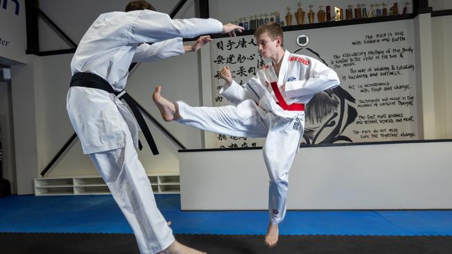 Liam Johnson (right) shows his style against older brother Noah at the Shingokan Karate School, Virginia. Picture: Ben Clark