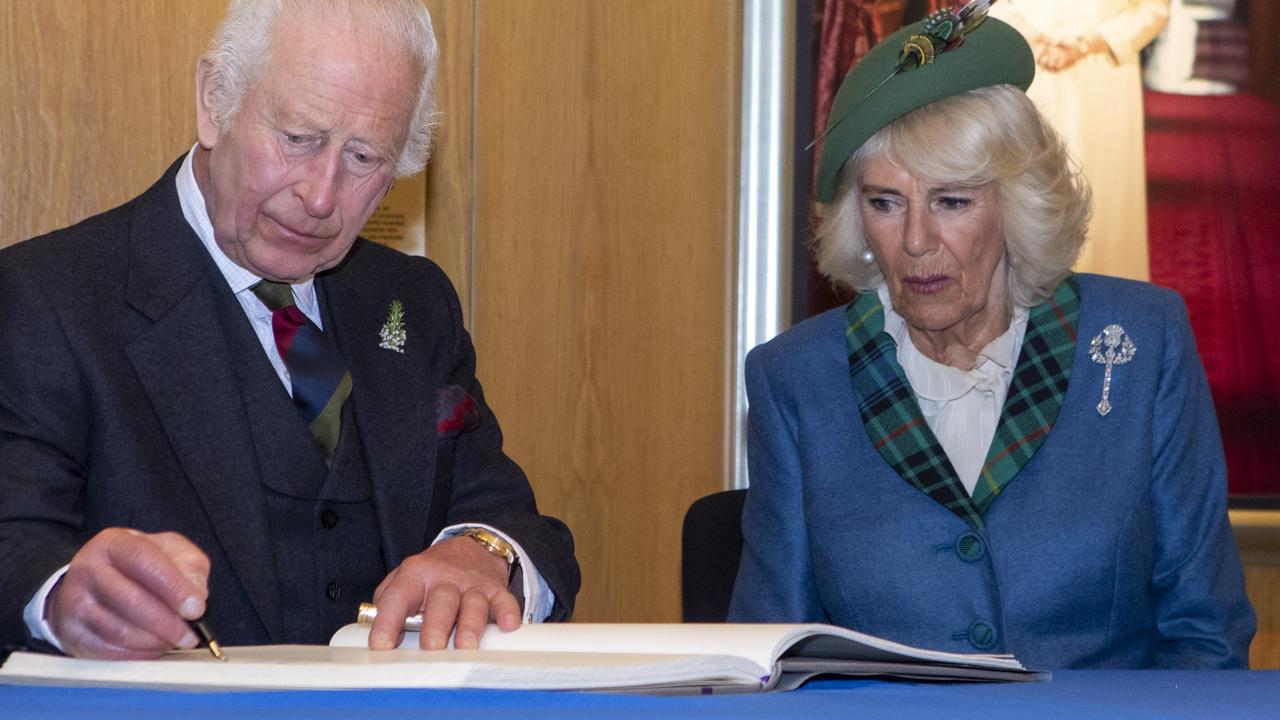 King Charles III and Queen Camilla sign the Visitors’ Book at the Scottish parliament on September 28. The pair will visit Australia this month. Picture: Katielee Arrowsmith/The Scottish parliament via Getty Images