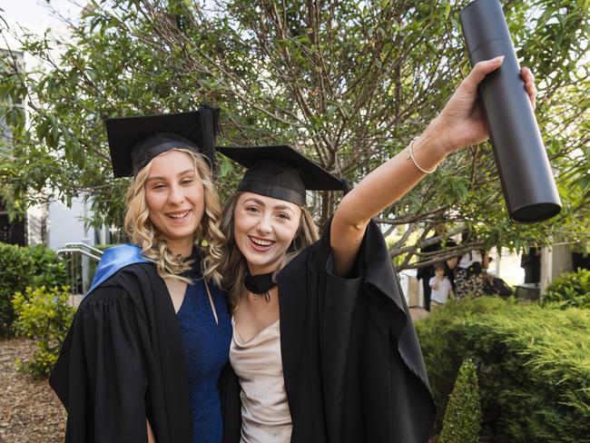 Sienna Deegan (left) and Kassidy Bauer met at placement and graduate together with a Bachelor of Nursing at a UniSQ graduation ceremony at Empire Theatre. Picture: Kevin Farmer