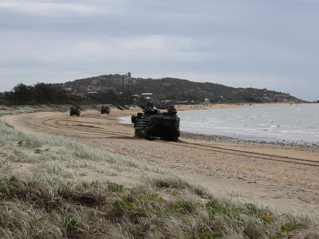 A series of Japanese and United States AAVP-7A1 amphibious vehicles track their way up Kings Beach in Bowen.