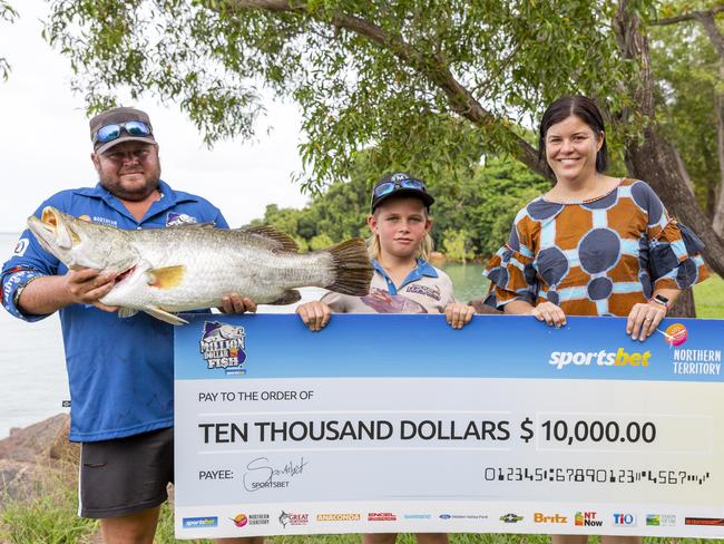 Dad Josh and son Jesse James holding their prize $10,000 barra with Tourism Minister Natasha Fyles. Picture: Floss Adams.