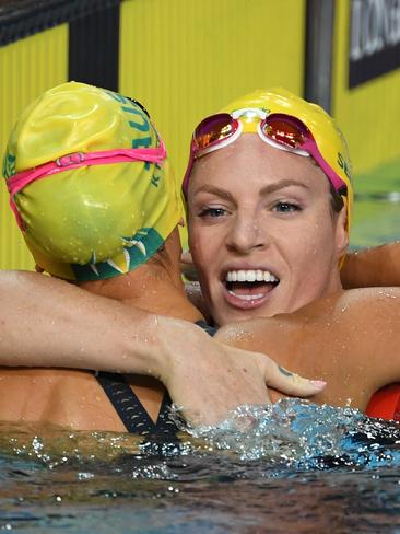 Emily Seebohm is hugged by Kayla McKeown after the Women's 200m Backstroke. Picture: AAP Image/Dave Hunt