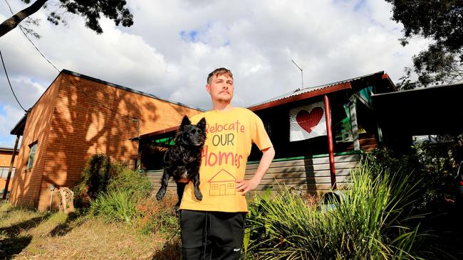 Lismore resident Harper Dalton with his dog Lemon show off the damage to his home after the extreme floods earlier this year. Picture: NCA NewsWire/ Scott Powick