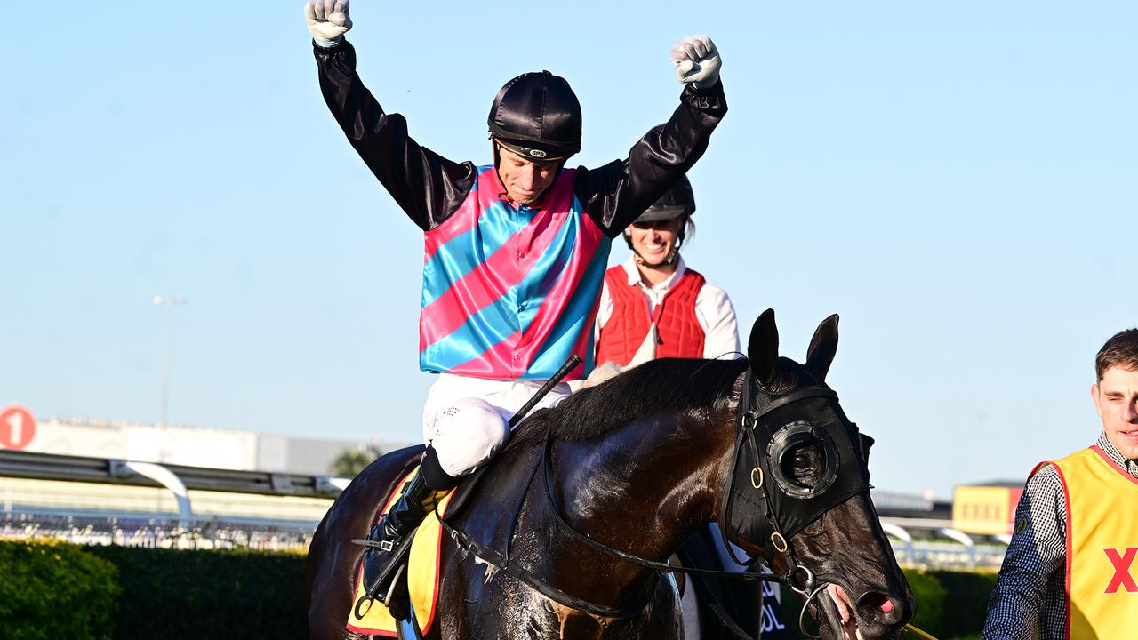 Jockey Blake Shinn raises his arms in triumph as he comes back to scale on Doomben Cup winner Antino. Picture: Grant Peters / Trackside Photography