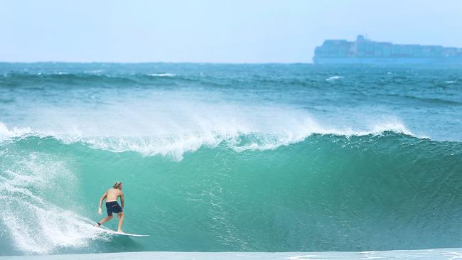 A surfer take advantage of the swell at Alexandra Headland. Photo Lachie Millard