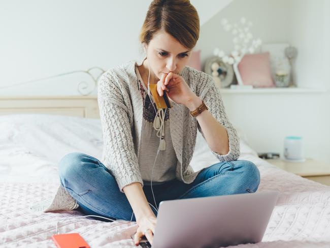 Coronavirus.  Picture: istock Young woman in the bedroom using laptop for planning the home finances