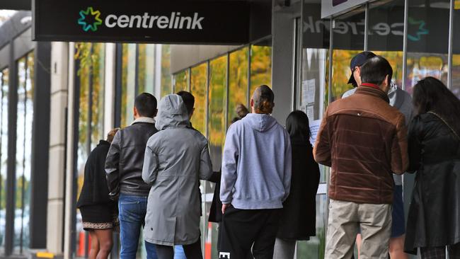 People queue up outside a Centrelink office in Melbourne.