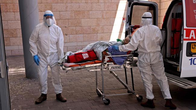 Medics with the Magen David Adom transfer a coronavirus patient to the Hadassah Ein Kerem Hospital in Jerusalem due to a lack of beds in other hospitals. Picture: AFP