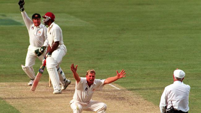 Shane Warne celebrates the wicket of Ian Bishop.