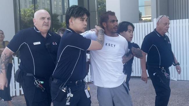 Ezra Austral was restrained by security after evading G4S court security, jumping over the barrier and running down the street at Darwin Local Court on Thursday, May 29. Picture: Zizi Averill