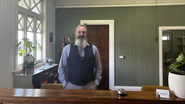 Mat Foley: founder of Wolf Real Estate Agent at the front desk on the first day of opening