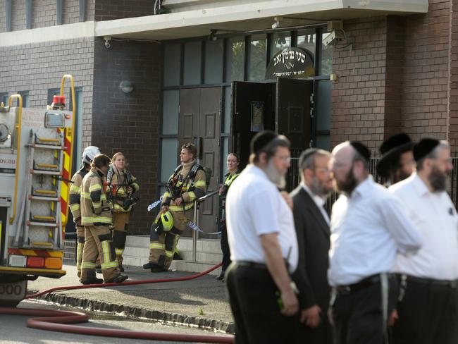 People gather outside a synagogue at East St Kilda after an overnight fire. Picture: Andrew Henshaw