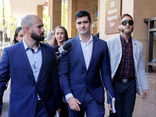 Jacob Hersant (centre) leaving Melbourne Magistrates court with his supporters. Picture: David Geraghty