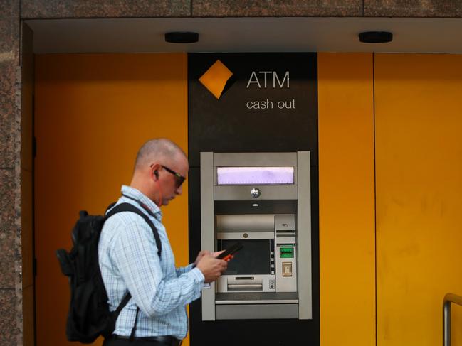 SYDNEY, AUSTRALIA - FEBRUARY 26: Pedestrians walk past a Commonwealth Bank of Australia (CBA) ATM on February 26, 2024 in Sydney, Australia. Commonwealth Bank's latest financial results reveal a robust performance, with the bank reporting a record profit of $9.6 billion for the 2022-23 fiscal year, underscoring its position as Australia's largest and most profitable lender. The strong earnings were driven by solid loan growth, improved margins, and a focus on cost control, positioning the bank for continued success in a challenging economic environment. (Photo by Lisa Maree Williams/Getty Images)