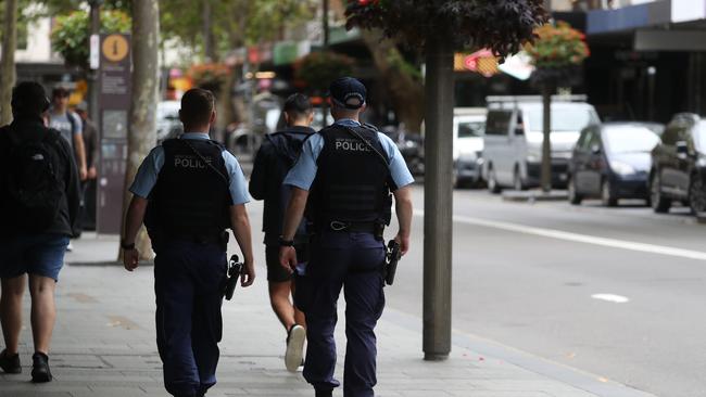 NSW Police walking along Darlinghurst Road in inner Sydney. Picture: John Grainger