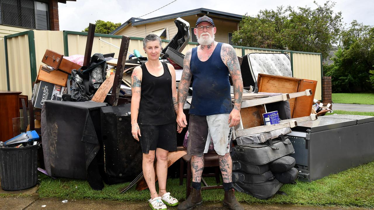 Tina Harvey and Phil Devine in front of all the damaged belongings at their home in Federation Drive, Bray Park. Picture: John Gass