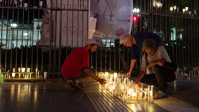 Faithfuls light candles for Pope Francis at Piramide de Mayo monument during a Torchlight March in Buenos Aires, Argentina.