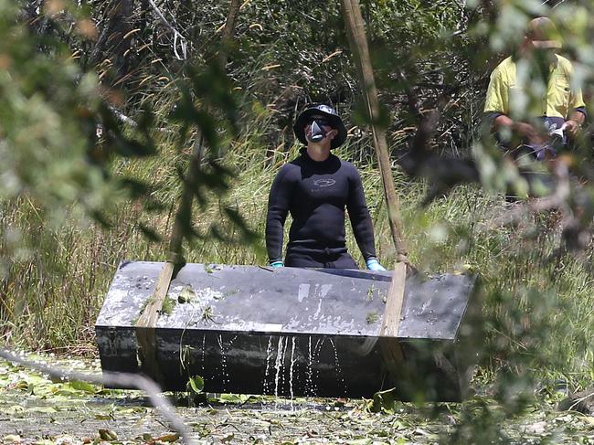 Toolbox murder -  Police retrieve a metal box from a dam near Srubby Creek in Kingston, double murder Logan. Pic Jono Searle.