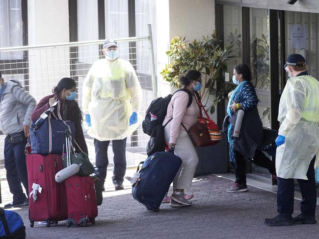 Travellers arrive at Hobart's Best Western Hotel after a repatriation flight from Inda arrived at Hobart. Picture Chris Kidd