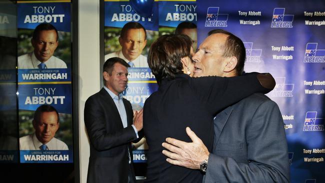 Tony Abbott is hugged by his wife Margie after making a speech during his election night party in Manly. Picture: Braden Fastier