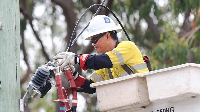 Energex workers get on with recovery efforts outside HOTA and Bundall. Picture Glenn Hampson