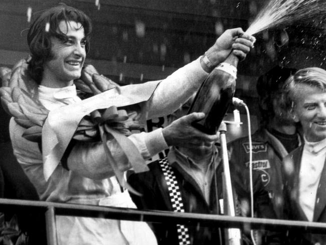 Peter Brock spraying the crowd with champagne after his breakthrough win in 1972.