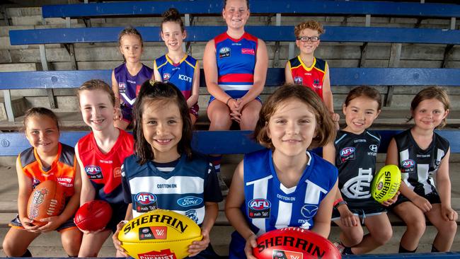 Ten young girls in the jumpers of all the 2019 AFLW teams, including the two newcomers, Geelong and North Melbourne. Picture: Jay Town