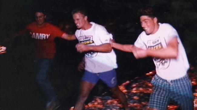 Former Adelaide Crows star Nigel Smart walking over hot coals during firewalk motivational exercise that went wrong and burnt his feet in January 1992.