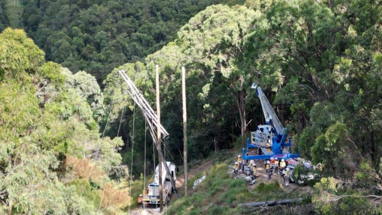 Energex workers at Bonogin in the Gold Coast hinterland after Cyclone Alfred.