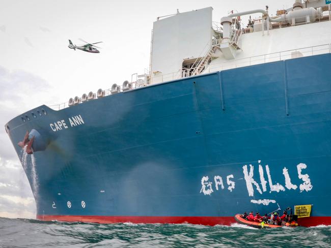 Greenpeace France activists scrawl the words 'Gas Kills' on the side of the TotalEnergies Cape Ann LNG terminal, anchored off the northern French port city of Le Havre, in the English Channel. Picture: Lou Benoist/AFP