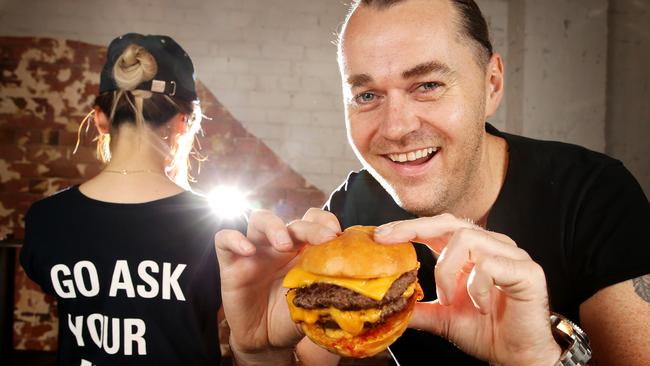 Fine-dining chef Shannon Bennett enjoing at burger at his new burger shop Benny Burger. Picture: Norm Oorloff