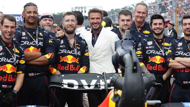 David Beckham stands with the Red Bull Racing team