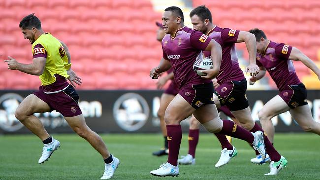 Queensland players Ben Hunt and Josh Papalii at Suncorp Stadium yesterday.