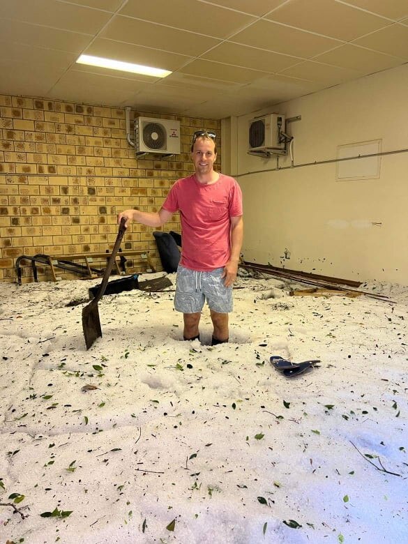 Dan Heaton cleans up after the overnight storm.