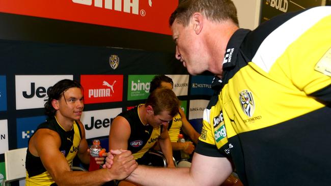 Damien Hardwick shakes hands with Daniel Rioli.