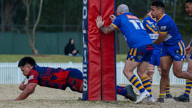 Jacob Oloaga dives over for a Collegians try. Picture Thomas Lisson